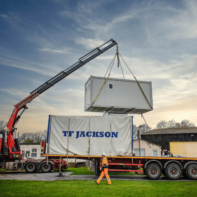 A TF Jackson portable building being craned off a lorry