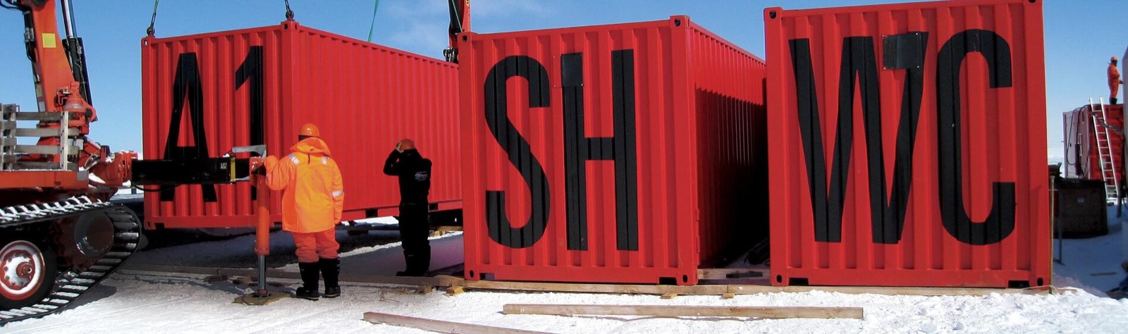Red container conversion units marked A1, SH and WC being prepared for the Antarctic